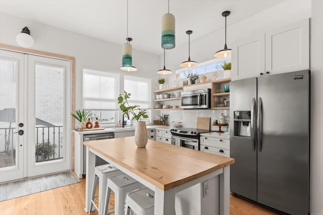 91 Oneida St, Saint Augustine, FL 32084 - kitchen with wood counters, open shelves, white cabinets, stainless steel appliances, and a sink