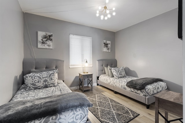 bedroom with a chandelier and hardwood / wood-style floors