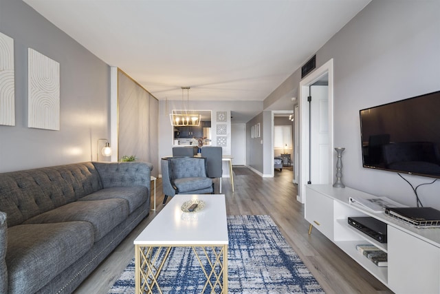 living room featuring hardwood / wood-style floors and an inviting chandelier