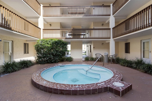 view of pool featuring an in ground hot tub and a patio