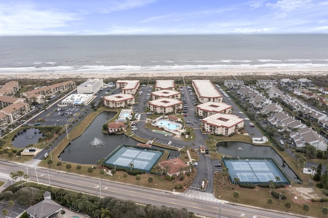 birds eye view of property with a beach view and a water view