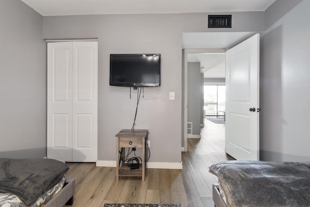 bedroom featuring light hardwood / wood-style flooring and a closet