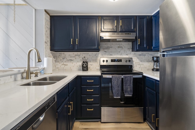 kitchen featuring blue cabinetry, decorative backsplash, sink, and stainless steel appliances