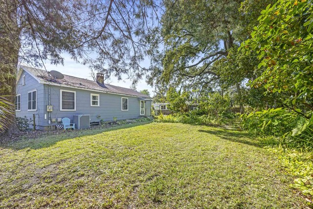 240 Ravenswood Dr, Saint Augustine, FL 32084 - view of front of home with asphalt driveway and a front lawn