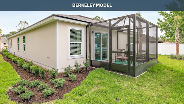 view of side of home featuring a lanai and a yard