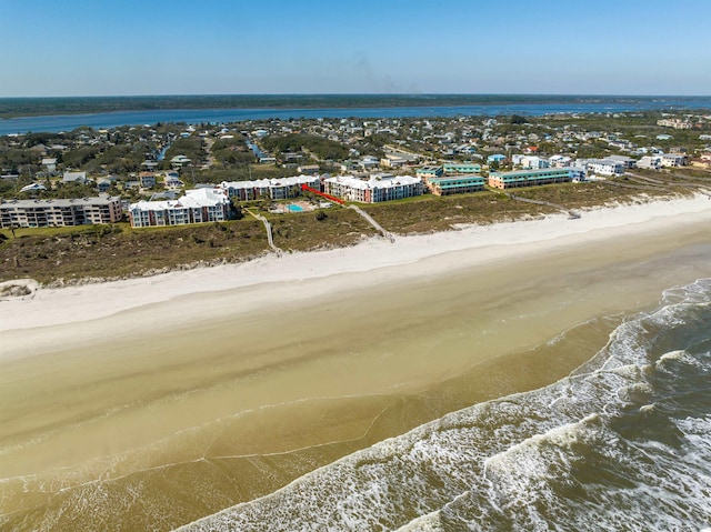 birds eye view of property with a view of the beach and a water view