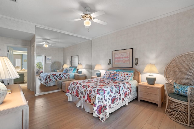 bedroom with crown molding, ceiling fan, and hardwood / wood-style floors