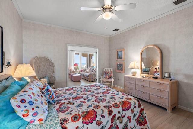 bedroom featuring crown molding, ceiling fan, and light wood-type flooring