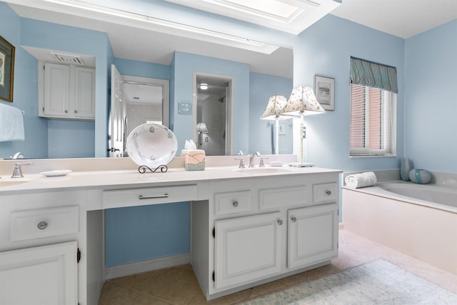 bathroom featuring vanity, a bathing tub, and tile patterned flooring