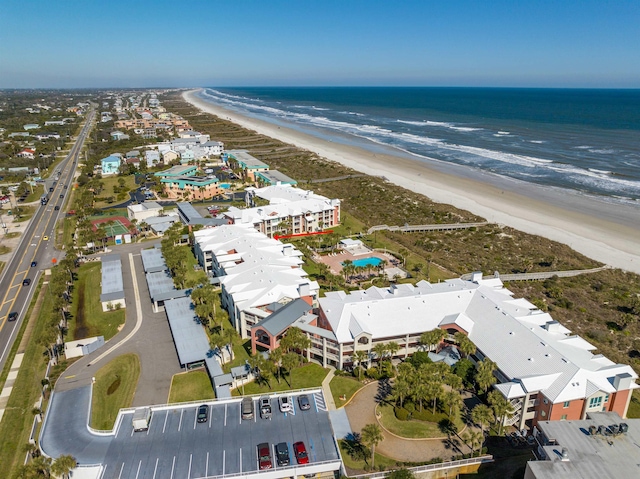 bird's eye view featuring a water view and a beach view