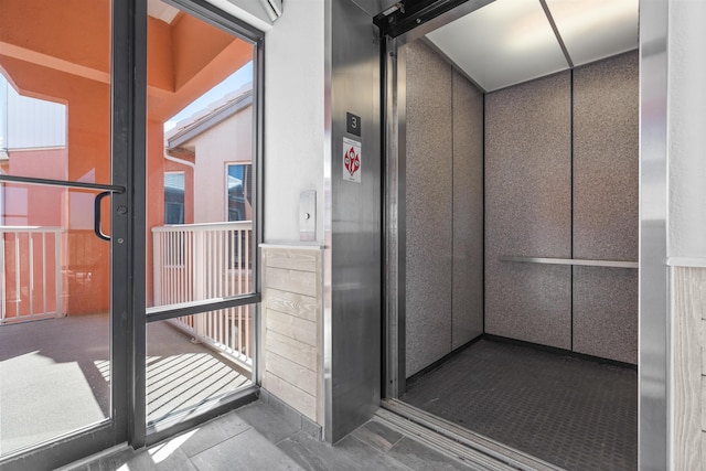 bathroom with a healthy amount of sunlight and elevator