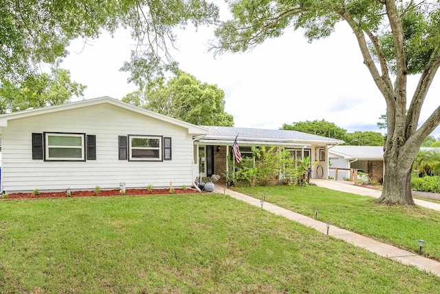 single story home with a front lawn and a carport