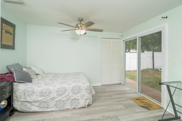 bedroom with a closet, access to exterior, ceiling fan, and light hardwood / wood-style flooring