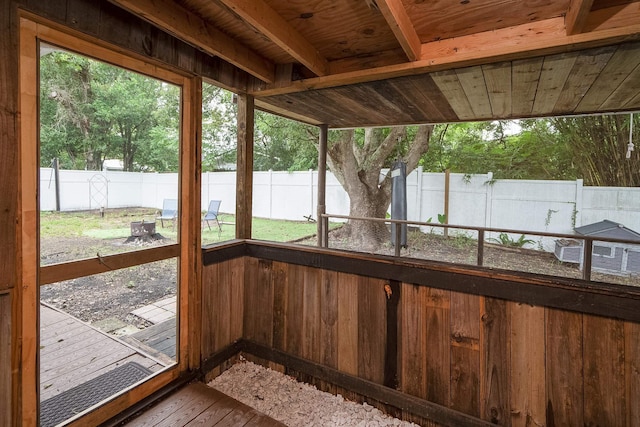 unfurnished sunroom with wooden ceiling