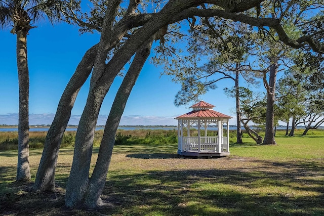 view of community featuring a gazebo, a water view, and a yard