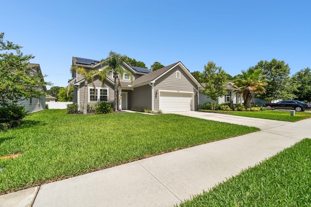 view of front of property featuring a garage, a front yard, and solar panels