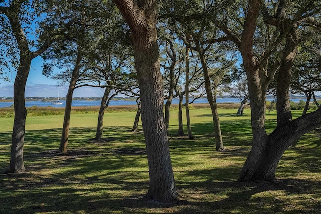 exterior space with a water view and a lawn