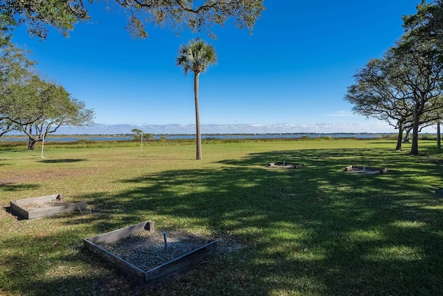 view of property's community with a yard and a rural view