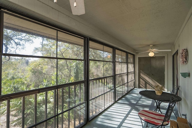 sunroom featuring ceiling fan