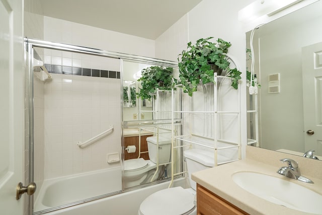 full bathroom featuring bath / shower combo with glass door, vanity, and toilet