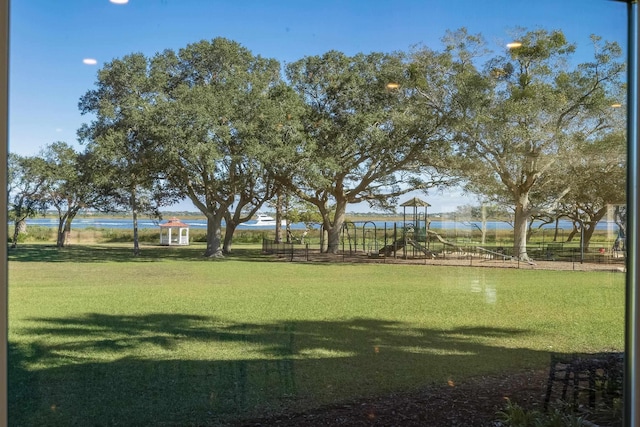 view of property's community with a yard and a playground