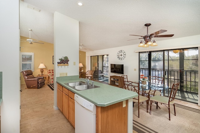 kitchen with sink, light wood-type flooring, white dishwasher, kitchen peninsula, and ceiling fan