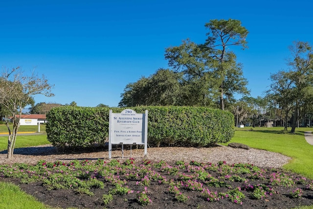 community sign featuring a lawn