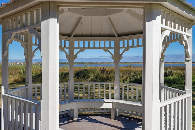 view of patio with a gazebo and a deck with water view