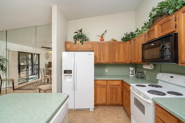 kitchen with white appliances, a textured ceiling, light hardwood / wood-style floors, and ceiling fan