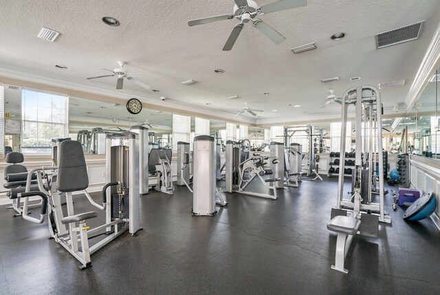 workout area featuring crown molding and a textured ceiling