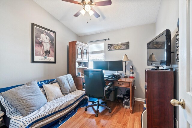 office space featuring a textured ceiling, wood-type flooring, ceiling fan, and vaulted ceiling