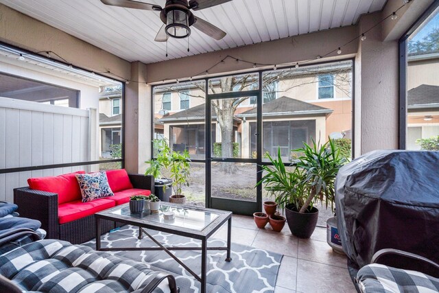 sunroom / solarium featuring ceiling fan