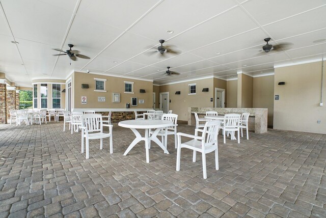 view of patio / terrace with ceiling fan and an outdoor bar