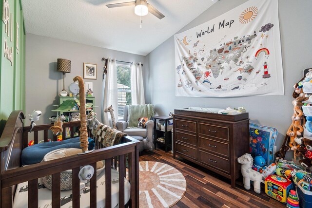 bedroom featuring ceiling fan, dark hardwood / wood-style flooring, and vaulted ceiling