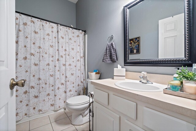 bathroom featuring tile patterned flooring, vanity, and toilet