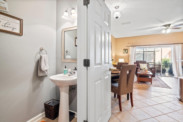 bathroom featuring sink, a textured ceiling, tile patterned floors, and ceiling fan