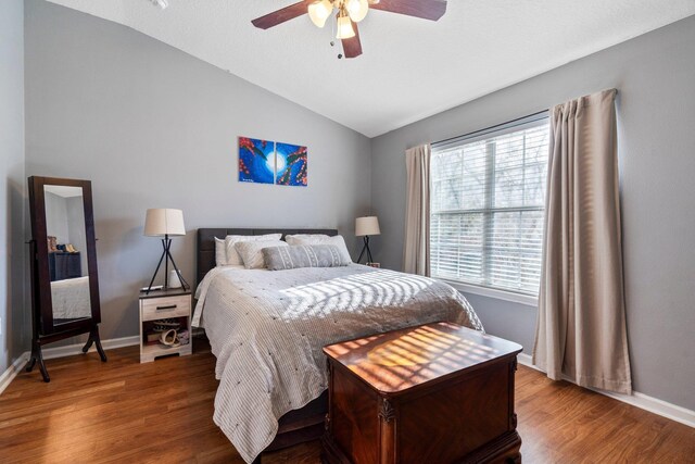 bedroom featuring ceiling fan, vaulted ceiling, and hardwood / wood-style floors