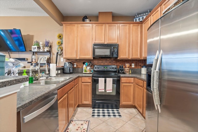 kitchen featuring light tile patterned flooring, backsplash, sink, and black appliances