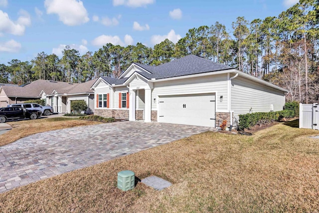 ranch-style home featuring a garage and a front lawn