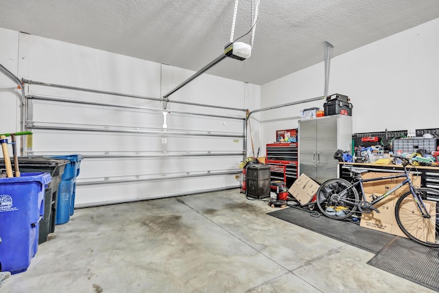 garage with a garage door opener and a workshop area