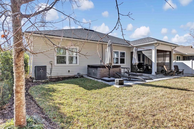 back of property featuring a sunroom, central AC unit, a patio, and a lawn