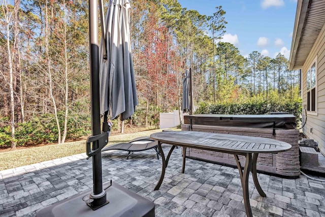 view of patio / terrace with a hot tub