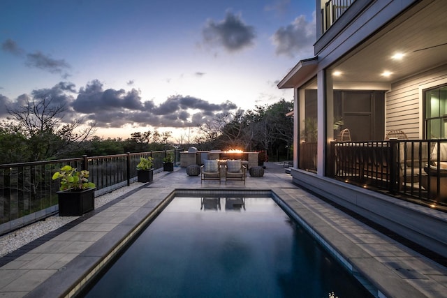 214 Pelican Reef Dr, Saint Augustine, FL 32080 - pool at dusk featuring a fenced in pool and a patio area