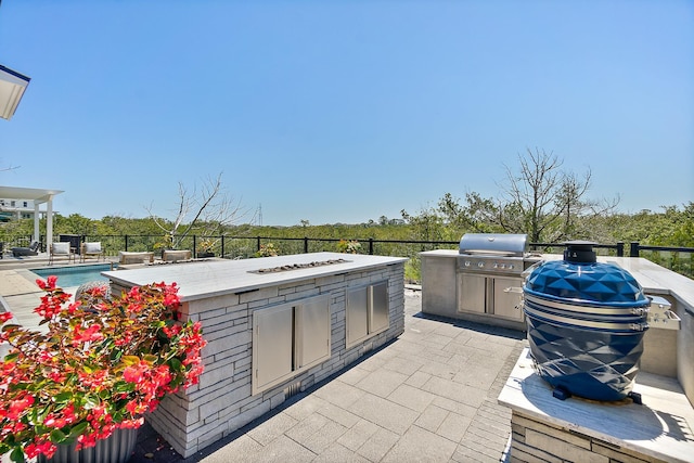 214 Pelican Reef Dr, Saint Augustine, FL 32080 - view of patio with an outdoor kitchen, a swimming pool, grilling area, and an outdoor fire pit