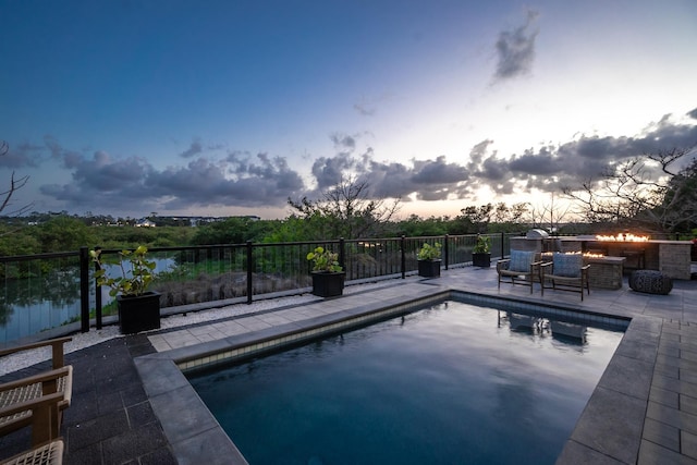 214 Pelican Reef Dr, Saint Augustine, FL 32080 - pool at dusk with fence, a patio, and a fenced in pool