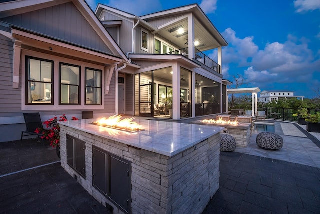 214 Pelican Reef Dr, Saint Augustine, FL 32080 - view of patio / terrace with an outdoor fire pit, fence, and a balcony