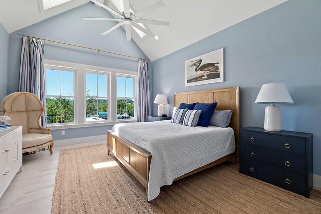 214 Pelican Reef Dr, Saint Augustine, FL 32080 - bedroom with a skylight, ceiling fan, baseboards, light wood-type flooring, and high vaulted ceiling