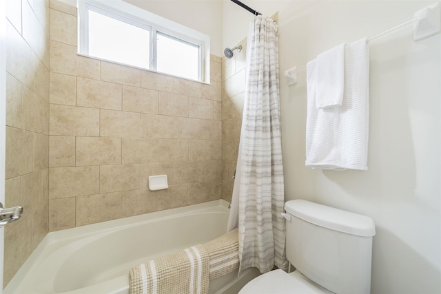 bathroom with shower / tub combo and toilet