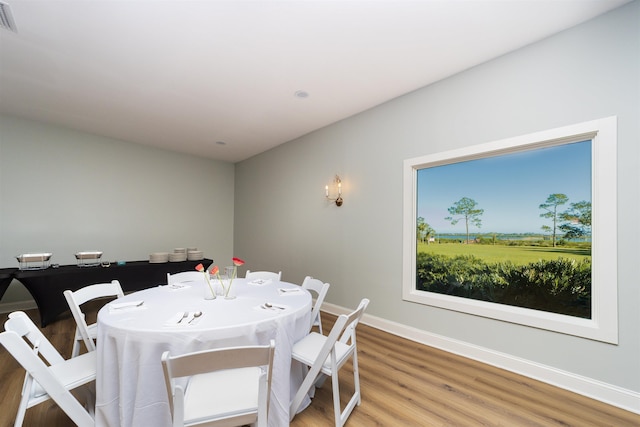 dining space featuring hardwood / wood-style floors