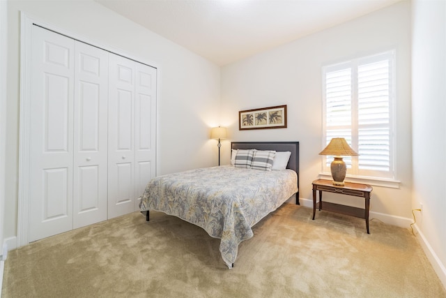 bedroom featuring light carpet and a closet